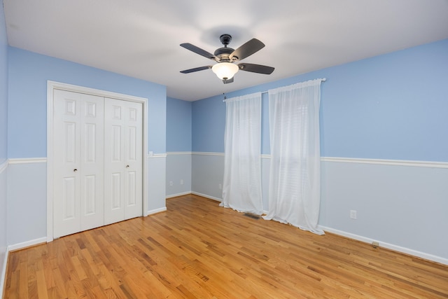 unfurnished bedroom featuring a closet, ceiling fan, and light hardwood / wood-style flooring