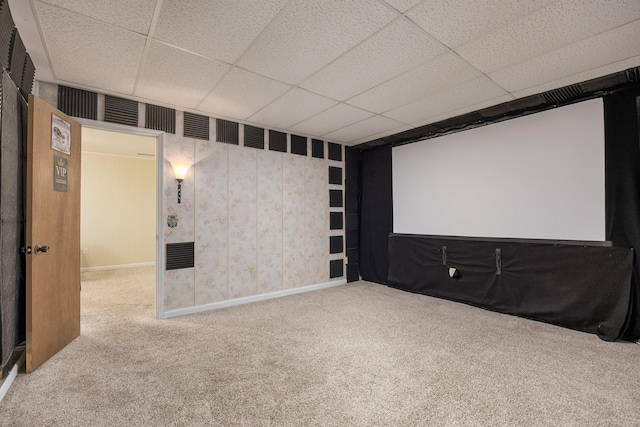 carpeted cinema featuring a paneled ceiling