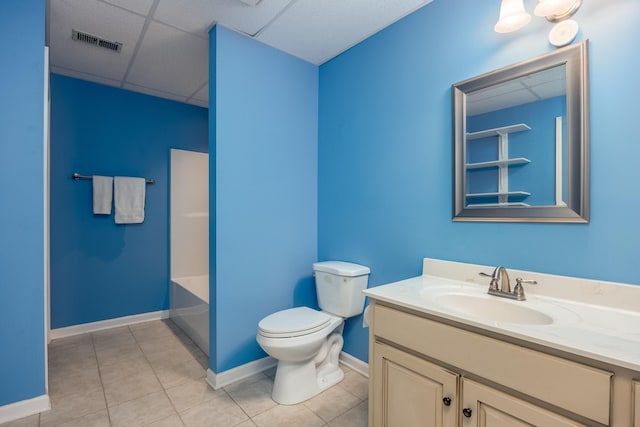 bathroom with tile patterned floors, a paneled ceiling, vanity, and toilet