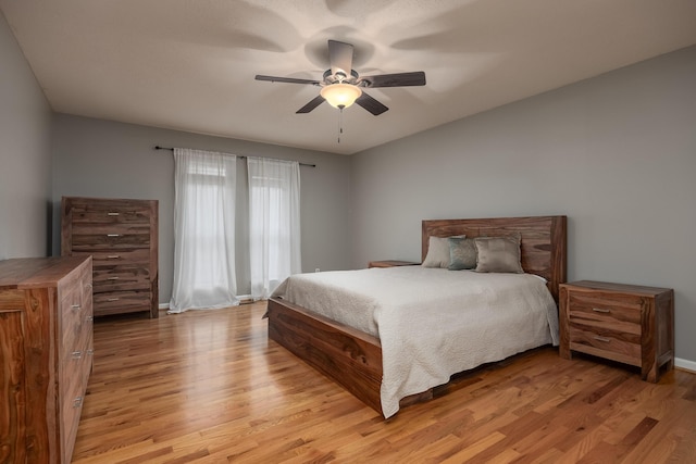 bedroom with light hardwood / wood-style flooring and ceiling fan