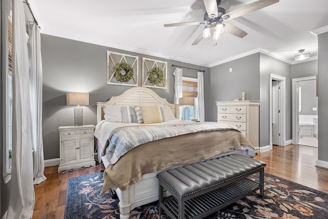 bedroom featuring ceiling fan, connected bathroom, crown molding, and dark hardwood / wood-style floors