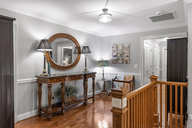 hall with hardwood / wood-style flooring and crown molding