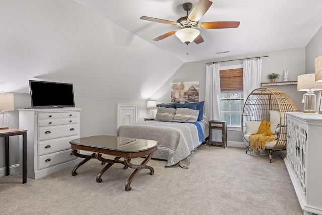 bedroom featuring ceiling fan, vaulted ceiling, and light carpet