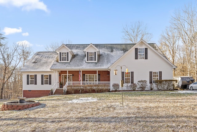 new england style home with a porch