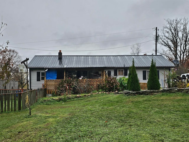 rear view of house with a yard