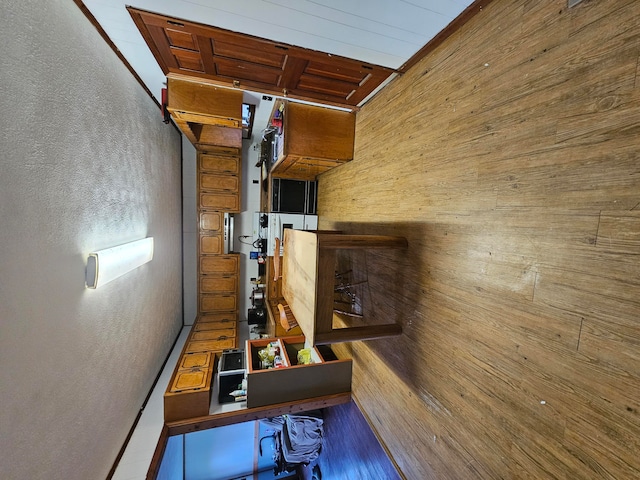 playroom featuring hardwood / wood-style floors, wooden ceiling, and wooden walls