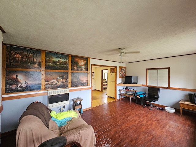 living room with a textured ceiling, heating unit, and hardwood / wood-style flooring