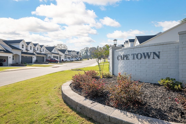 community sign featuring a yard