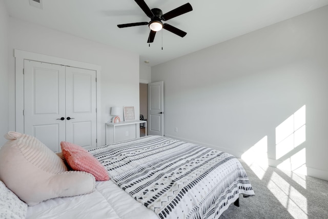 carpeted bedroom featuring ceiling fan and a closet