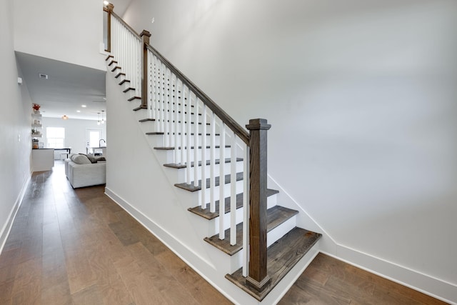 stairway featuring wood-type flooring