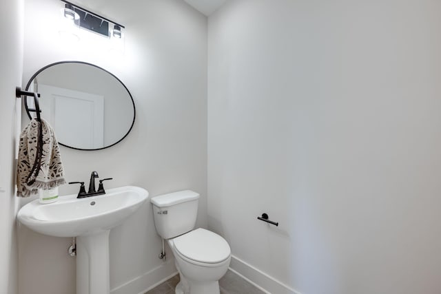 bathroom with tile patterned floors and toilet