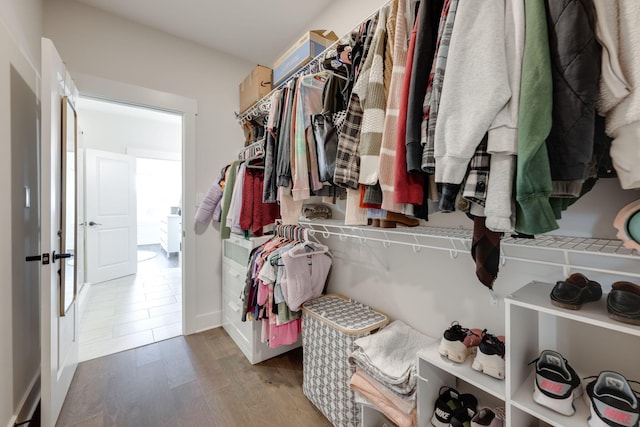 spacious closet featuring hardwood / wood-style floors