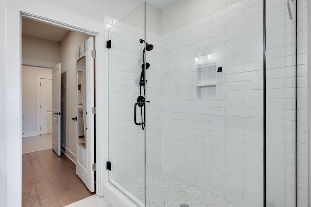 bathroom with hardwood / wood-style floors and walk in shower