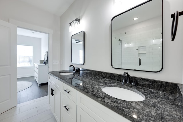 bathroom with hardwood / wood-style floors, vanity, and an enclosed shower