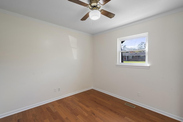 spare room featuring ceiling fan, wood-type flooring, and crown molding