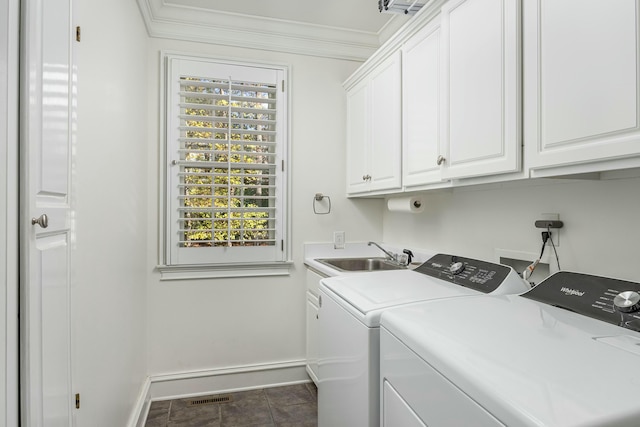 laundry area with cabinets, independent washer and dryer, ornamental molding, and sink