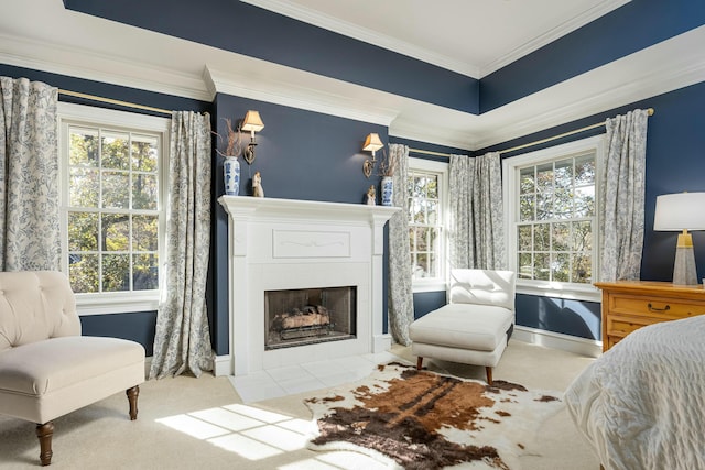 interior space featuring multiple windows, ornamental molding, and a tiled fireplace