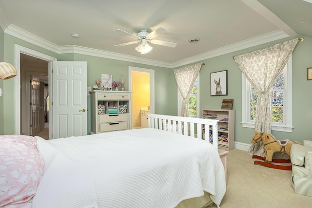 carpeted bedroom featuring multiple windows, ceiling fan, crown molding, and ensuite bathroom