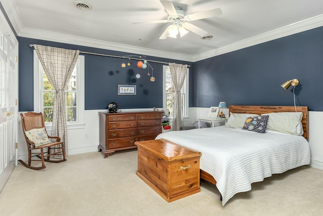 bedroom with ceiling fan, crown molding, and light carpet