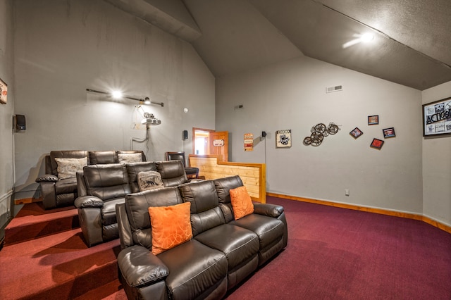 carpeted home theater featuring lofted ceiling