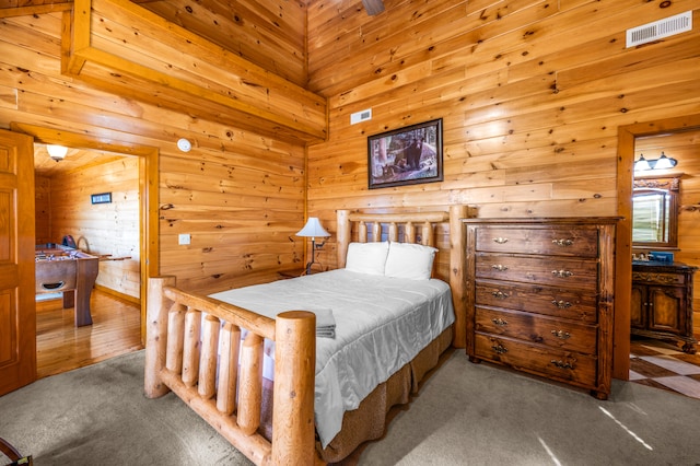 bedroom featuring wood walls and carpet floors