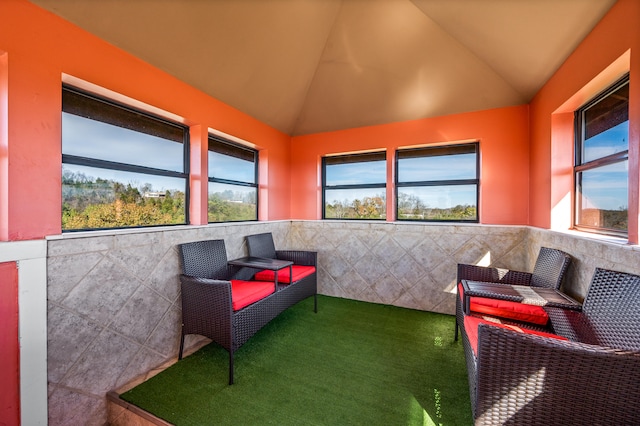 sunroom / solarium with plenty of natural light and vaulted ceiling