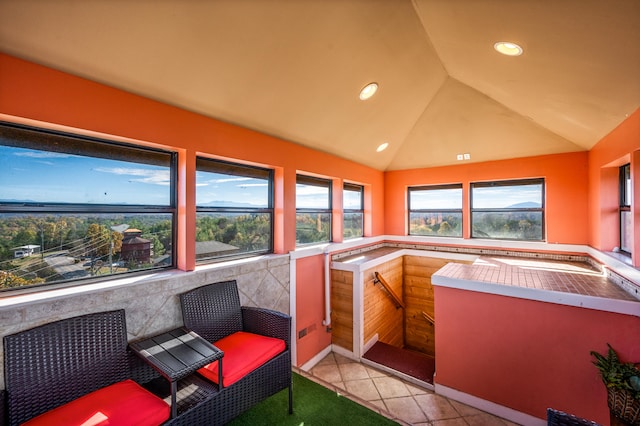 interior space with vaulted ceiling and a hot tub