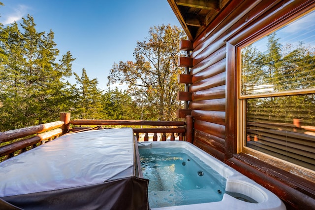 wooden deck featuring a hot tub