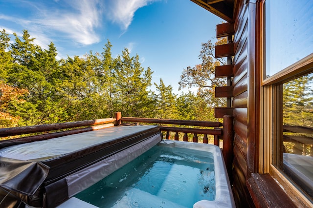 view of swimming pool featuring a hot tub