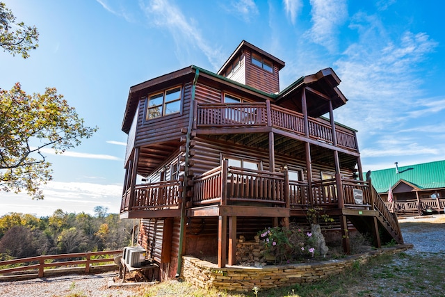 back of property featuring cooling unit and a wooden deck