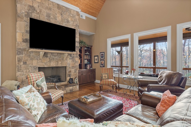 living room with a fireplace, high vaulted ceiling, plenty of natural light, and wood ceiling