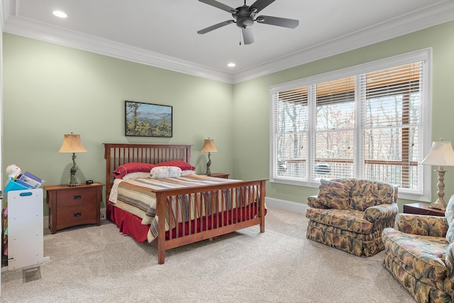 carpeted bedroom with ceiling fan and ornamental molding