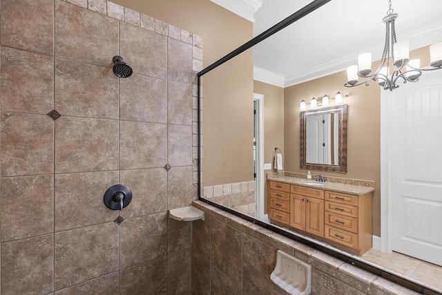 bathroom with vanity, a tile shower, ornamental molding, and a chandelier