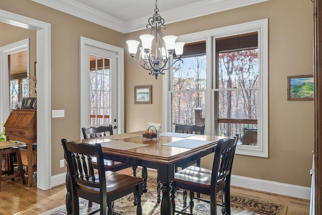 dining space with a wealth of natural light, a chandelier, and light hardwood / wood-style floors