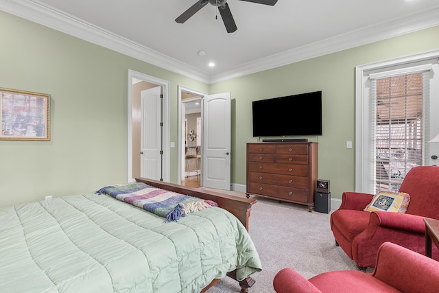 carpeted bedroom featuring ceiling fan and ornamental molding