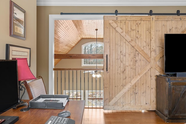 interior space with a barn door, hardwood / wood-style floors, wood ceiling, and lofted ceiling