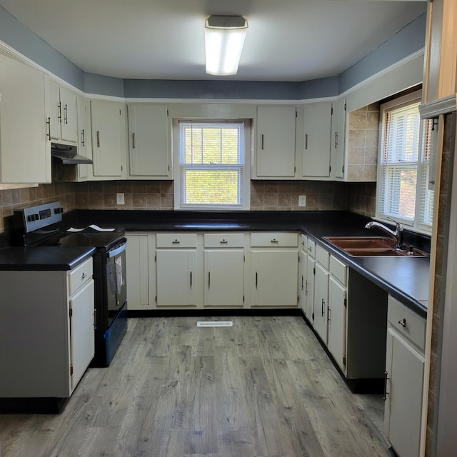 kitchen featuring black electric range oven, white cabinets, sink, tasteful backsplash, and light hardwood / wood-style floors