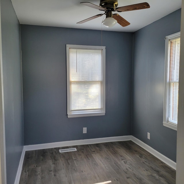 unfurnished room with ceiling fan and dark hardwood / wood-style flooring