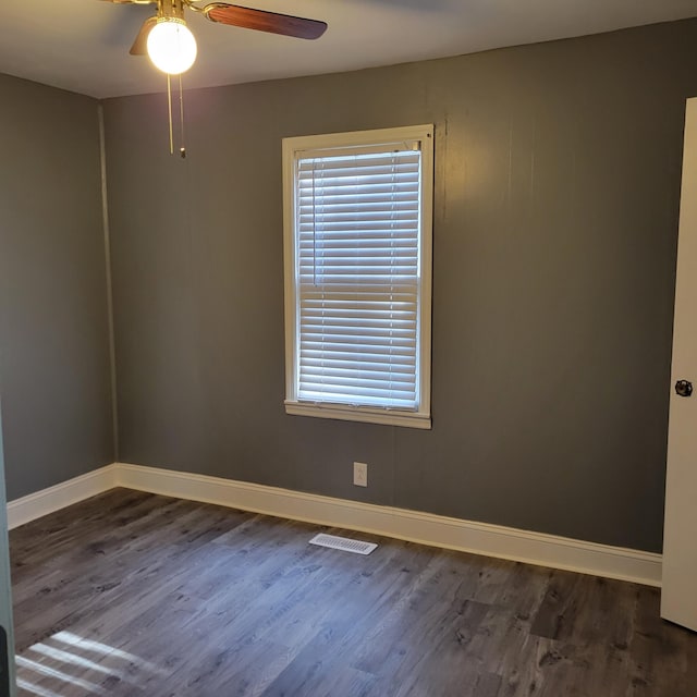 spare room featuring ceiling fan and dark wood-type flooring