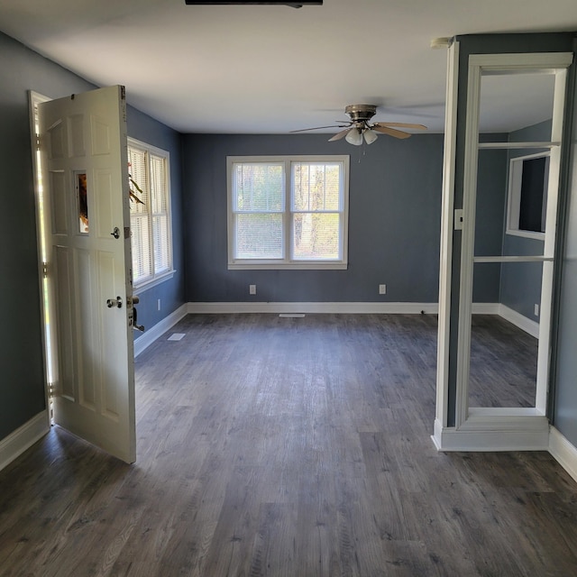 interior space with dark hardwood / wood-style floors and ceiling fan