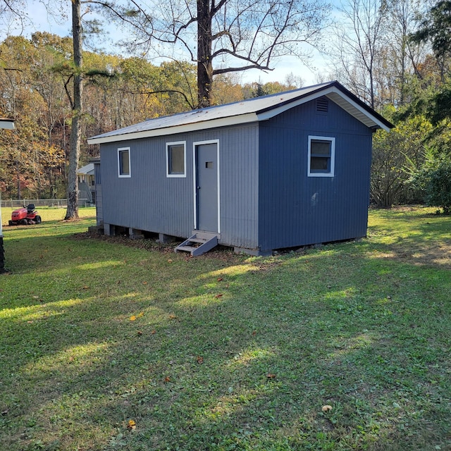 view of outbuilding with a yard