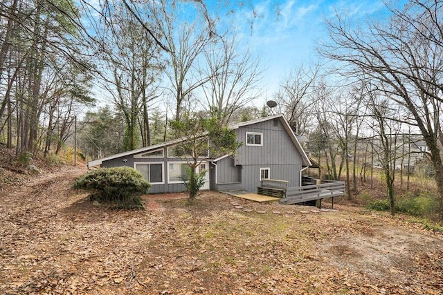 view of property exterior with a wooden deck