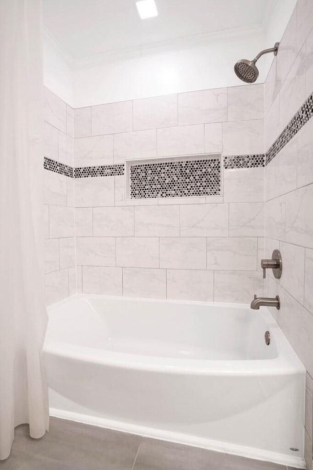 bathroom featuring crown molding and shower / bath combo with shower curtain