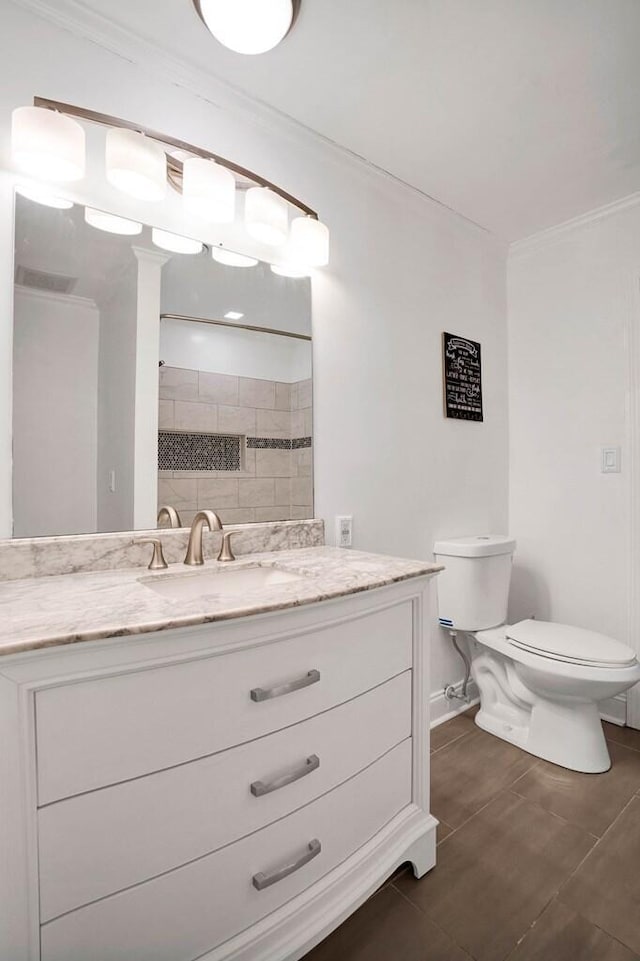 bathroom featuring a shower, tile patterned floors, vanity, and toilet