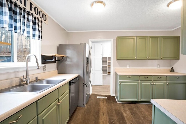 kitchen featuring appliances with stainless steel finishes, ornamental molding, sink, dark hardwood / wood-style floors, and green cabinets