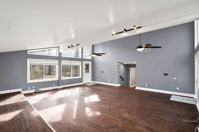 unfurnished living room with high vaulted ceiling and wood-type flooring