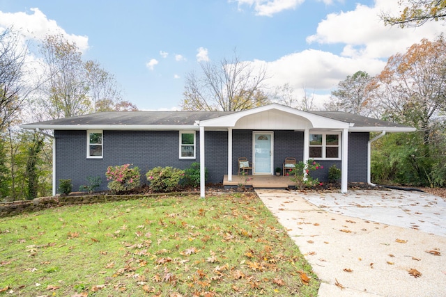 9100 Coventry Ln, Chattanooga, TN 37416 - single story home with brick siding, a front yard, covered porch, and concrete driveway