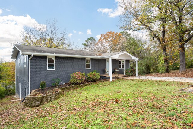 9100 Coventry Ln, Chattanooga, TN 37416 - view of front facade with brick siding, a front lawn, and a patio area