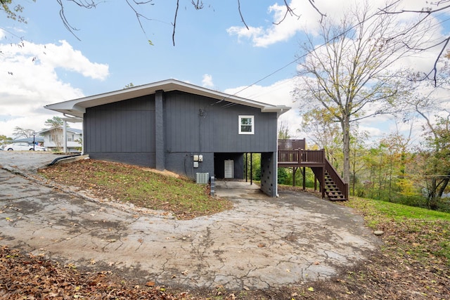 9100 Coventry Ln, Chattanooga, TN 37416 - view of property exterior featuring a carport, stairs, driveway, and cooling unit