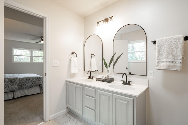 bathroom with ceiling fan, tile patterned flooring, vanity, and a healthy amount of sunlight